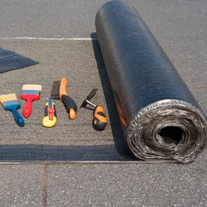 roll of roofing material and tools